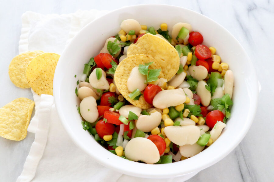 Salsa in center on top of white napkin. A few chips off to the left side.