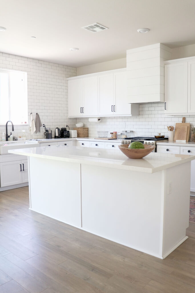 White farmhouse kitchen with white subway tile with black grout