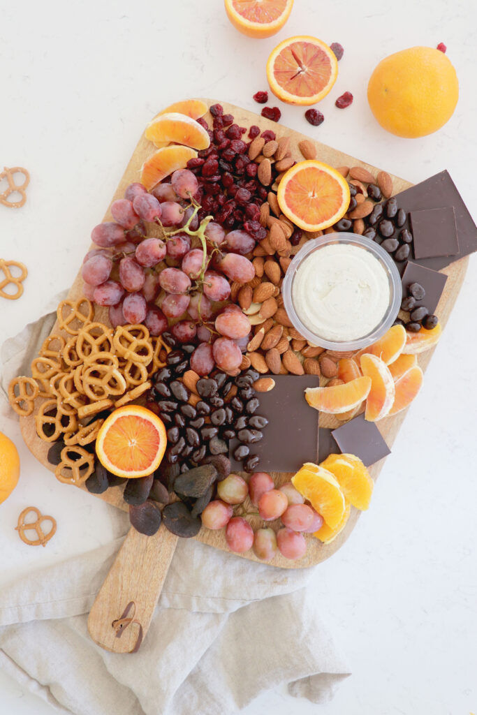 Wooden plank with an assortment of snacks.