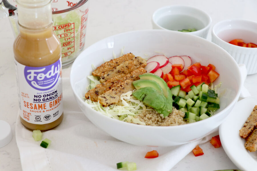White bowl with low fodmap foods and dressing on the side.