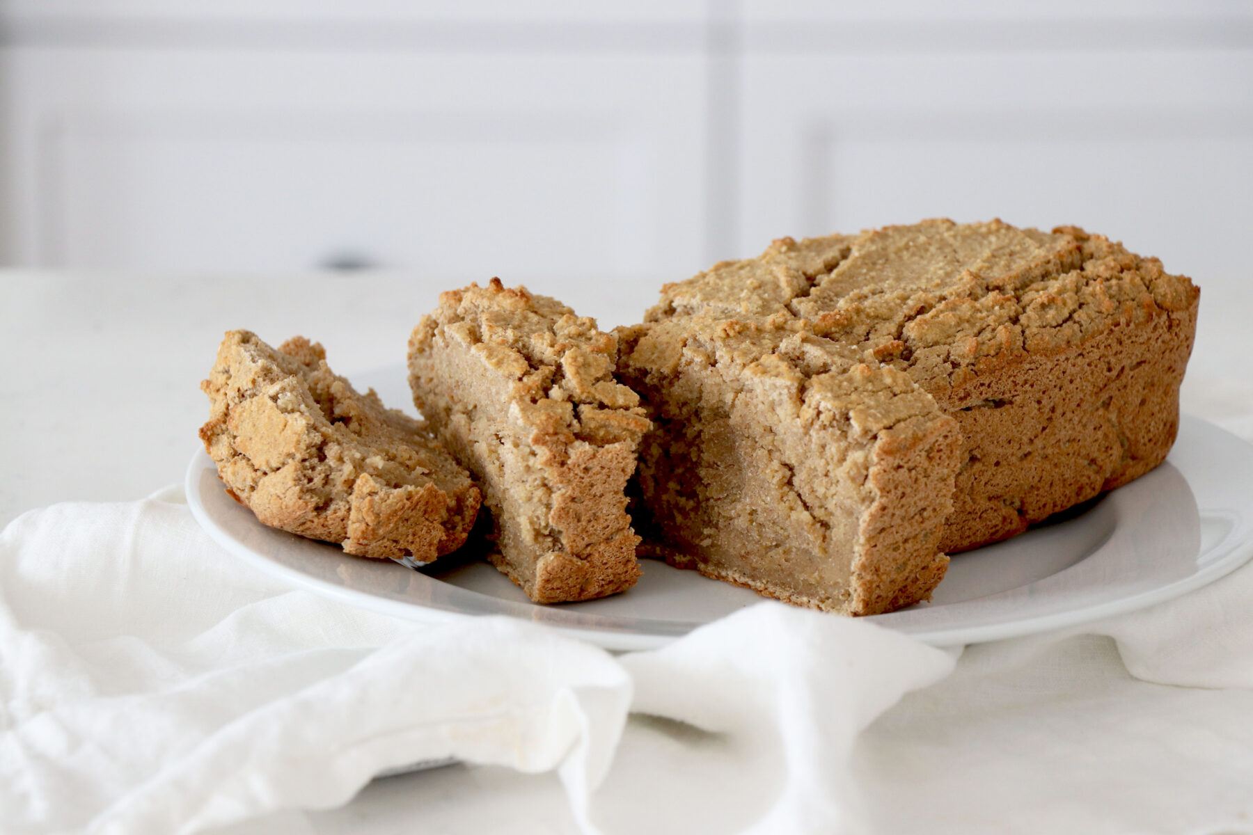 Gingerbread loaf on white napkin and plate.