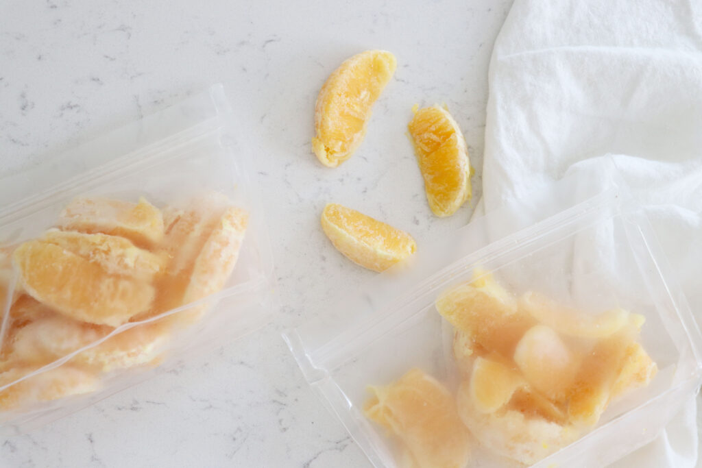 Frozen orange slices on the table and in bags.