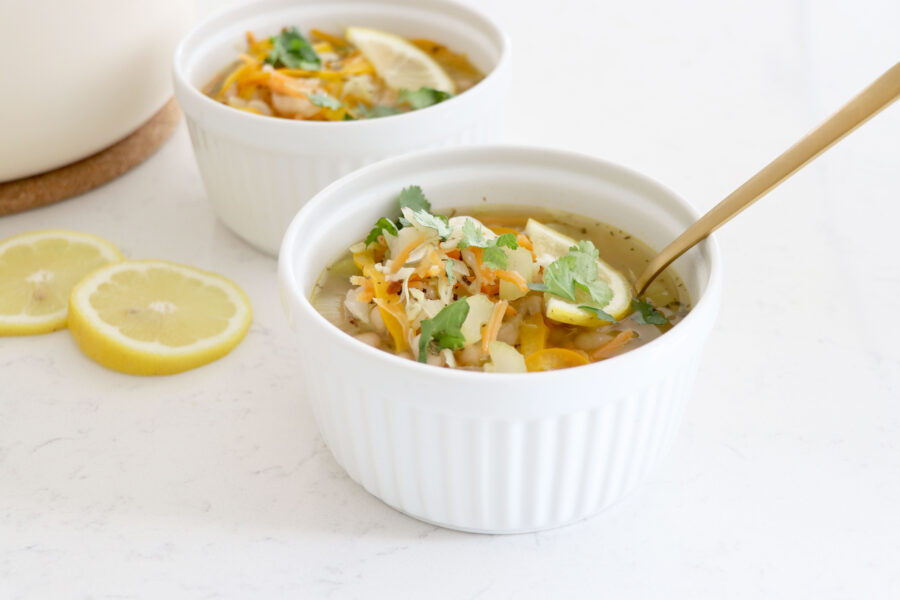 Bowls of soup with spoon in front bowl.