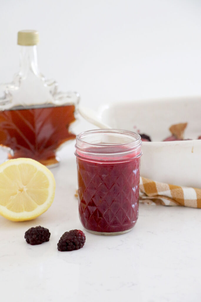 Open jar of blackberry marinade with Maple Syrup from Canada in background