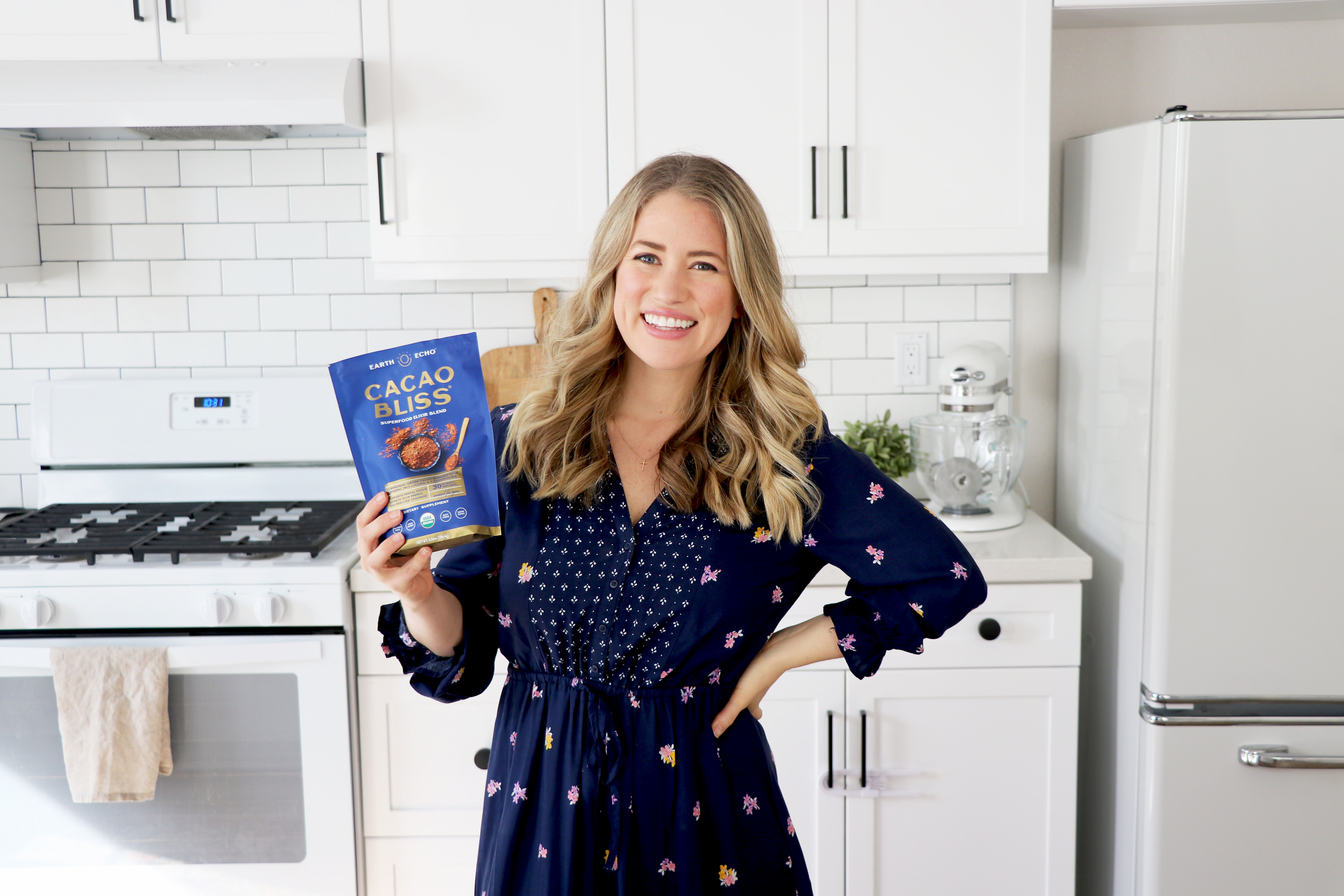 Megan holding Cacao Bliss bag in kitchen.