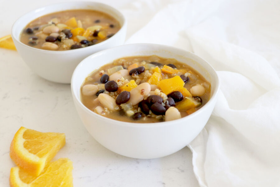 Small white bowls with chili and orange slices on the left side.