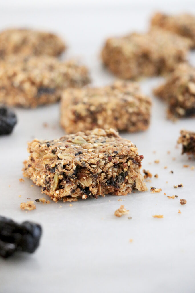 Vertical photo showing breakfast bars with prunes on the side.