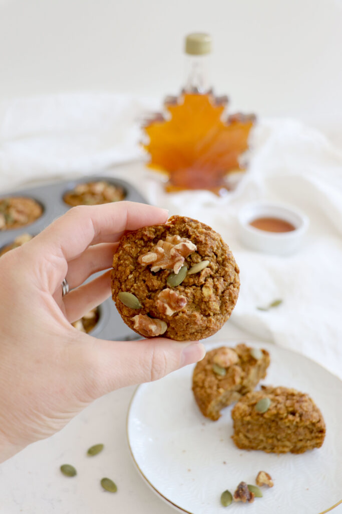 hand showing maple pumpkin muffin