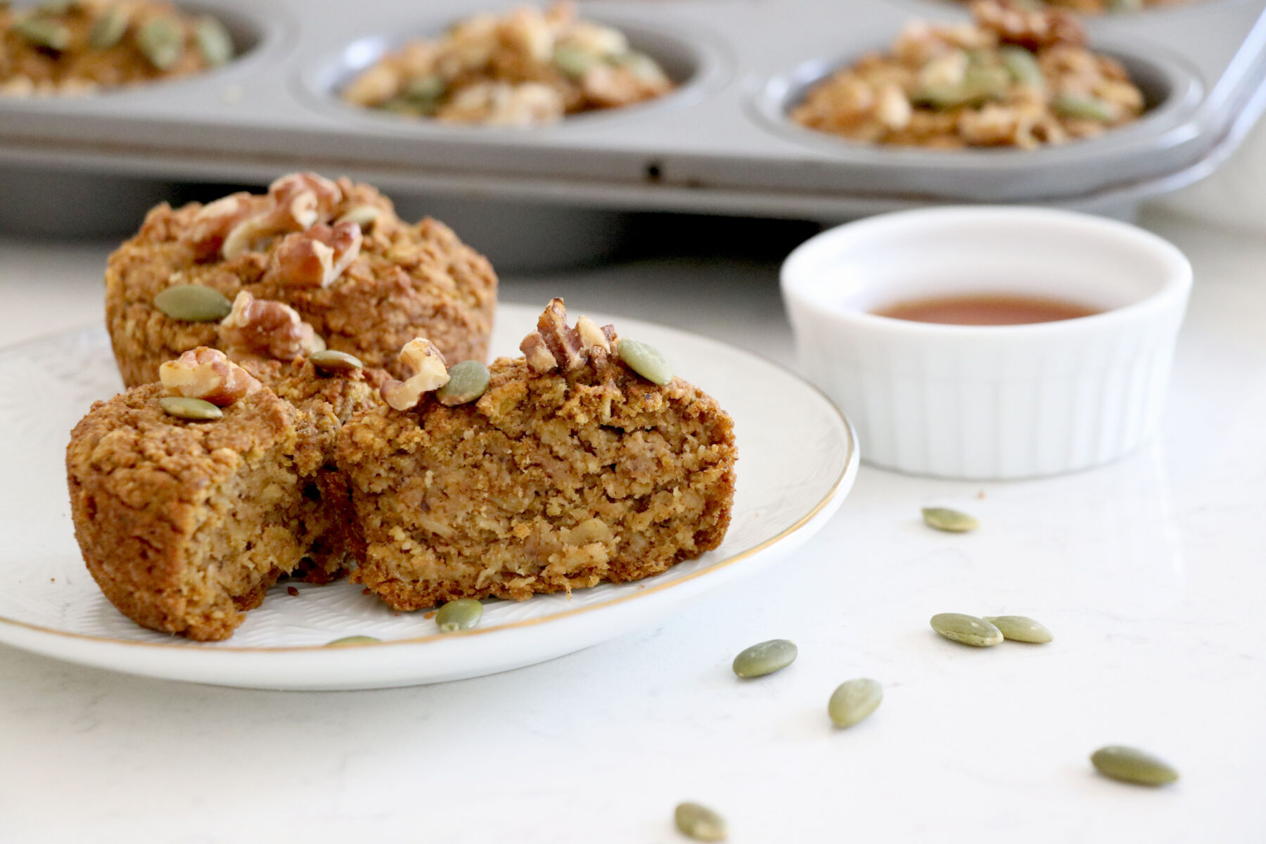 muffins on a small plate with maple syrup