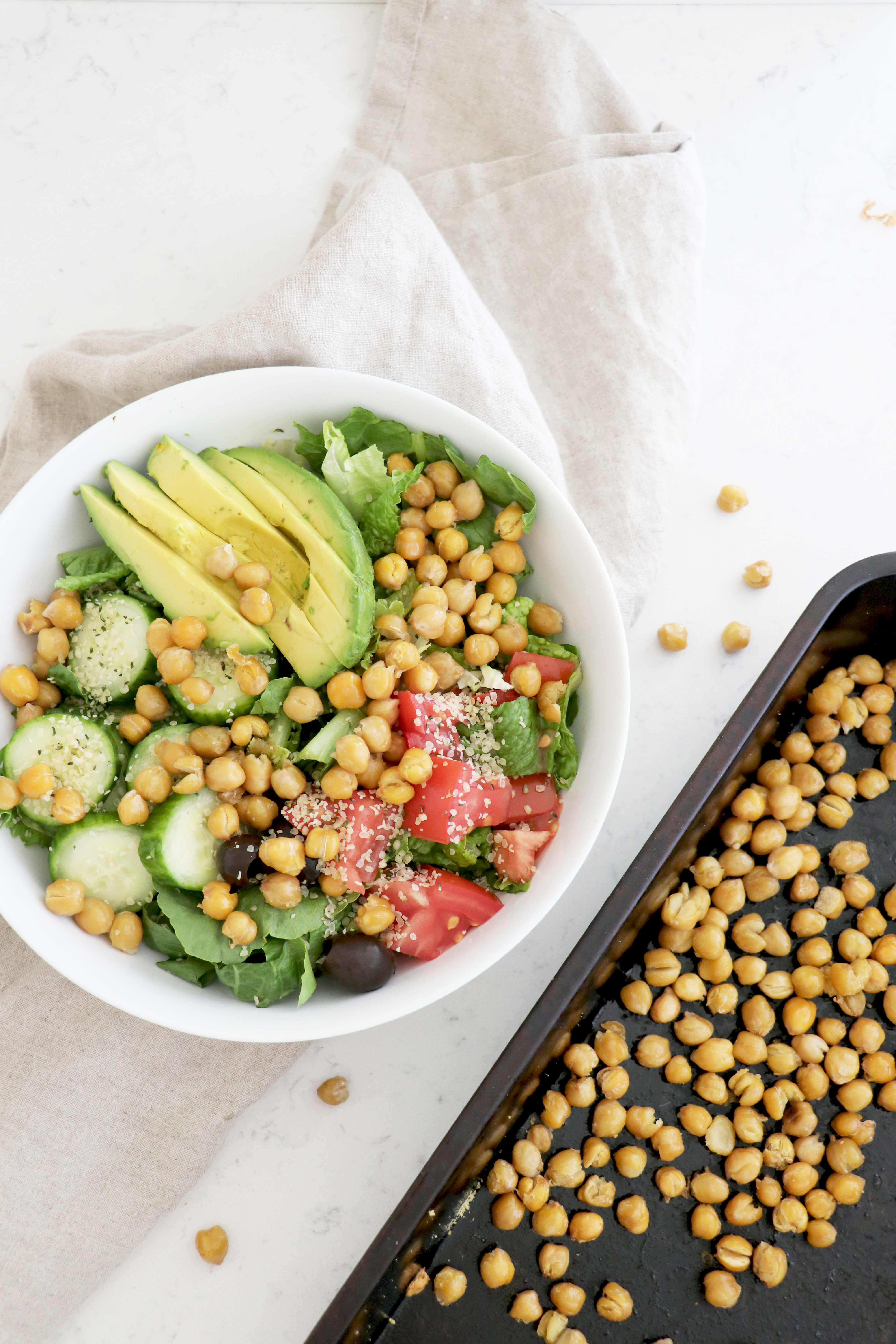 Bowl of salad with lettuce, avocado and crispy roasted chickpeas