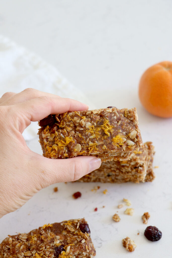 Hand holding cranberry orange snack bar